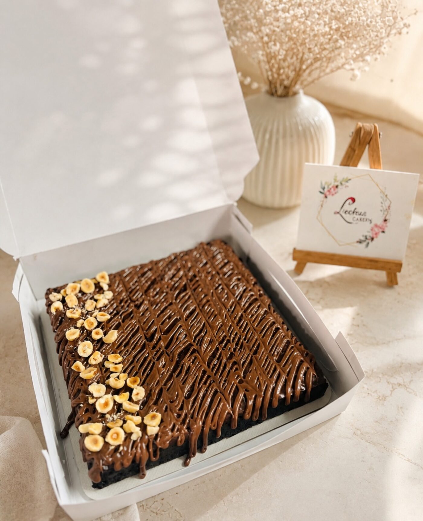 Fudgy brownie slab with hazelnuts in a gift box
