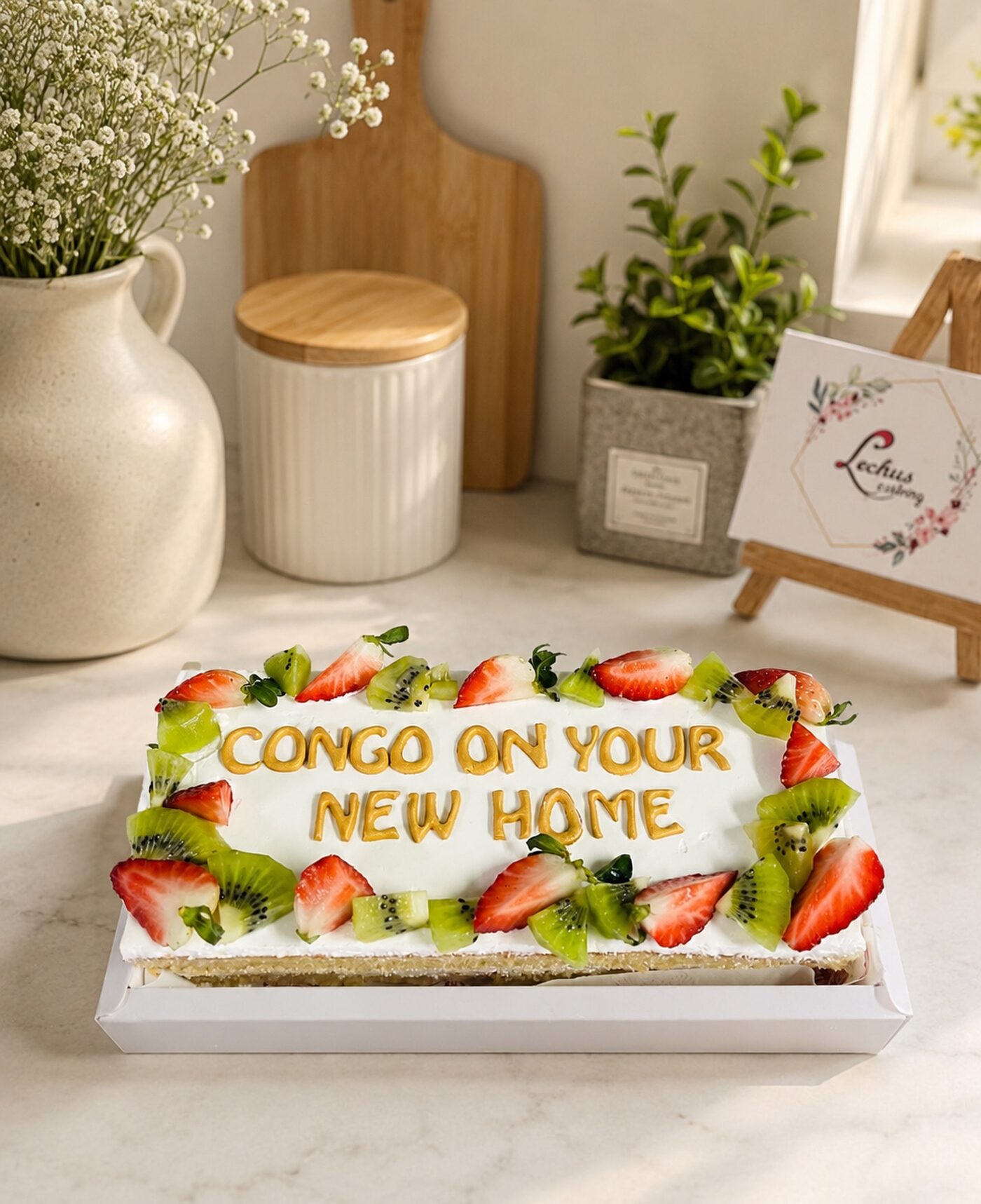 Fresh fruit celebration cake with a piped message